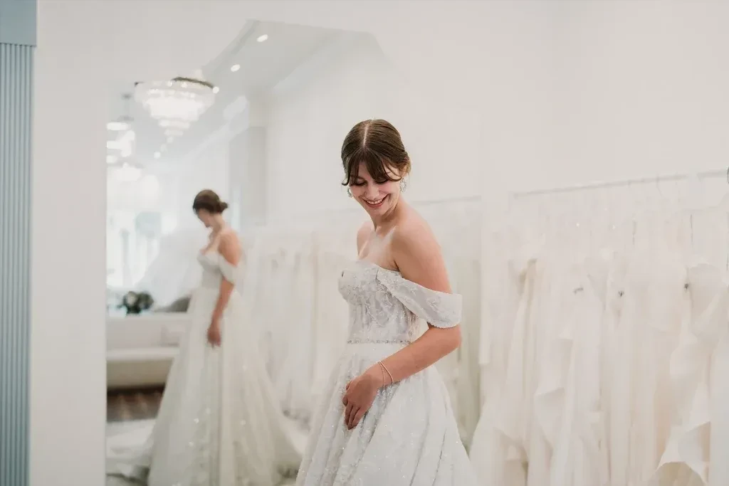 Happy bride trying on a wedding dress at Sinders Bridal House in Ottawa and Peterborough